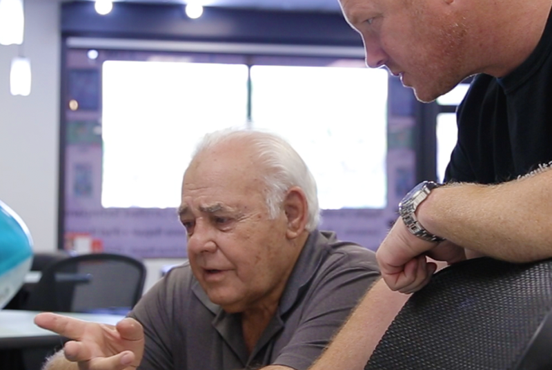 man and teacher learning apple computer instruction at Ubermac